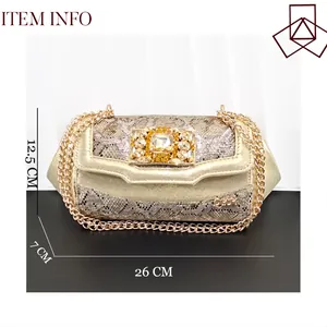 Golden snakeskin evening clutch with rhinestone buckle and 26cm size detail