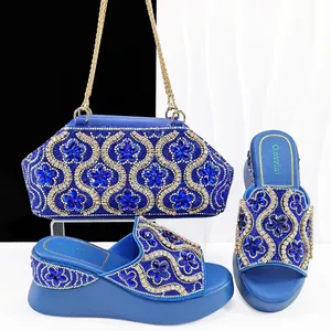 Elegant blue evening bag and matching wedge slides set with luxury floral rhinestones