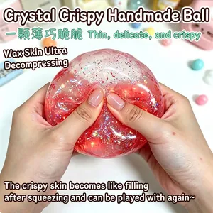 Detail of red glitter-filled crispy squishy toy ball being squeezed for stress relief.