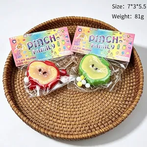 Detailed view of fruit-shaped stress relief pinch toys in their colorful packaging