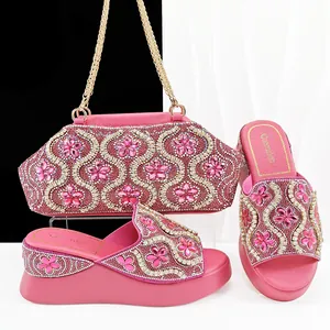 Close-up detail of pink wedge rhinestone slides and matching floral evening bag set.