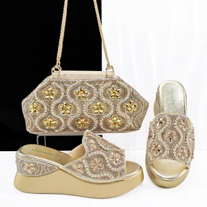 Detailed view of gold wedge platform sandals and matching rhinestone evening bag set