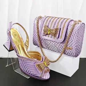 Detailed view of purple snakeskin pumps and matching handbag with rhinestone bow