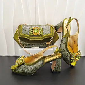 Detail view of olive green snake pattern high heels and matching rhinestone evening bag