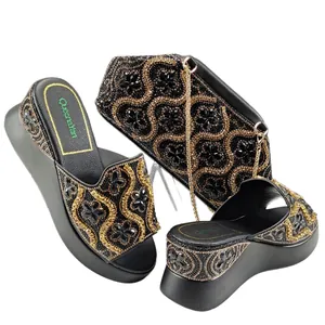 Elegant black and gold rhinestone wedge slides and matching floral clutch bag set
