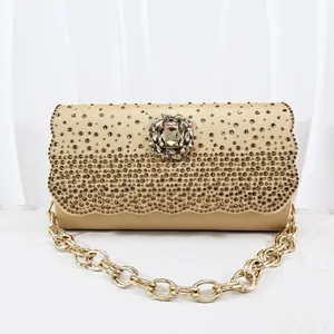Champagne gold evening clutch bag with sparkling rhinestones and crystal flower ornament