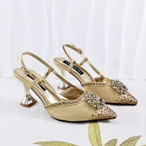 Elegant gold pointed toe sandals with rhinestone flower and flared high heels for banquet.