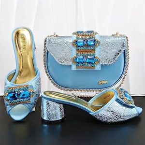 Elegant light blue open-toe block heel sandals and matching crystal saddle bag set