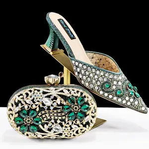 Detail view of emerald green rhinestone wedding shoes and matching clutch bag set