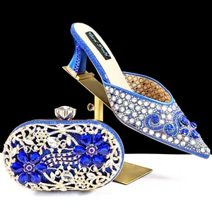 Close-up of royal blue rhinestone-embellished pointed-toe mules and matching clutch bag set