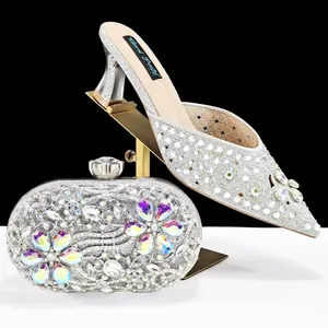 Detail view of silver rhinestone wedding shoes and matching floral clutch set
