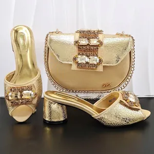Macro detail of gold cracked texture sandals and matching rhinestone saddle bag set