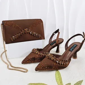 Elegant brown pointed-toe sandals and matching rhinestone-decorated envelope clutch bag set.