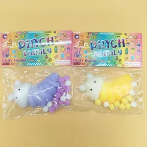 Detail of two colorful caterpillar squishy toys in retail packaging for stress relief