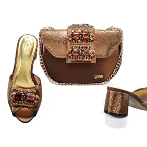 Bronze metallic open-toe chunky heel sandals with matching rhinestone saddle bag set.