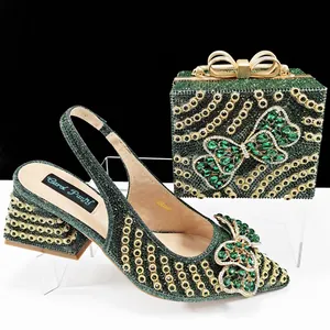 Elegant emerald green rhinestone pointed toe heels and matching bow clutch bag set