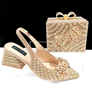 Macro detail view of luxury sparkling gold rhinestone shoe and bag set with butterfly accents.