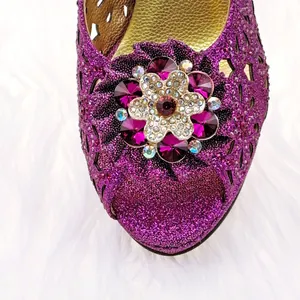 Detailed close-up of a purple glitter high heel sandal featuring an elegant rhinestone buckle