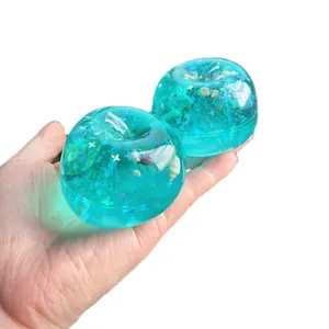 Lebendiges blaues Ozean-Apfel-Squishy-Spielzeug mit Muscheln und Sternen im Inneren