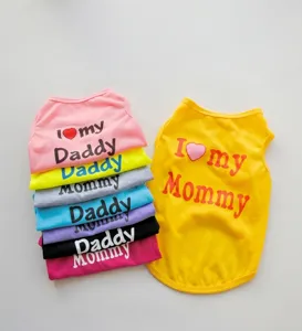 Macro detail showing colorful polyester pet vests with I Love my Daddy and Mommy prints.