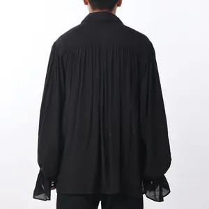 Macro view of the pleated back and ruffled cuffs on a black medieval men's shirt