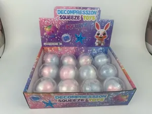 Detail view of 12-piece box of colorful decompression squeeze squishy toys in capsules