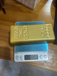 Close-up detail of a PU simulation gold bar slow rebound squishy toy on a digital scale