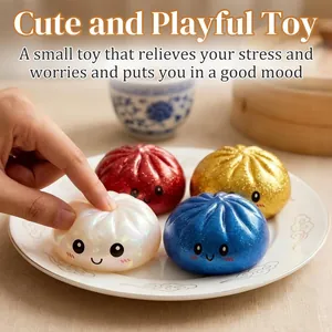 Hand squeezing a glittery white dumpling squishy toy for stress relief on a plate