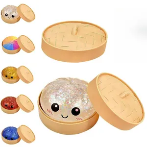 Glitter dumpling squishy toys in cute mini steamer boxes, multiple colors.