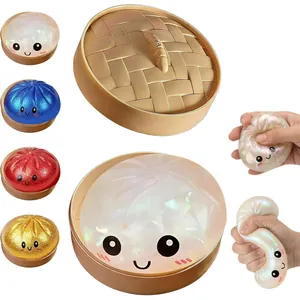 Glittery dumpling squishy stress relief toys with cute faces and a plastic steamer box