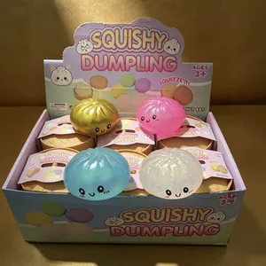Set of colorful cartoon smiley squishy dumpling squeeze toys in a display box for kids