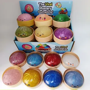 Bunte Glitzer-Dumpling-Squishy-Spielzeuge in Displaybox zum Stressabbau für Kinder.