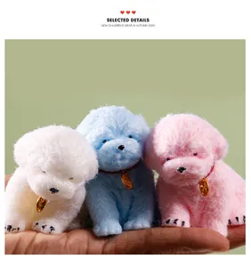 Three colorful TPR puppy dog decompression squeeze toys in white, blue, and pink held in a palm