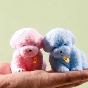 Pair of cute pink and blue dog-shaped TPR squishy stress relief toys on a hand
