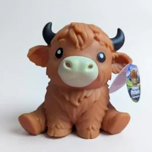 Detailed view of the orange Highland cow squishy toy featuring realistic horns and textures