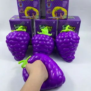 Close-up view of oversized purple grape squishy toy being squeezed for stress relief