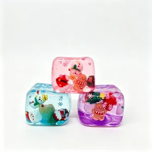 Macro view of three colorful Christmas squishy toys featuring Santa and gingerbread miniatures