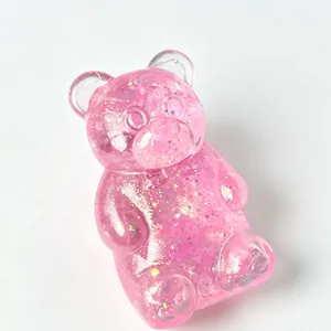 Pink glitter gummy bear squeeze toy in translucent finish for stress relief and play