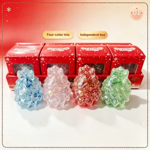 Close-up of four colorful glitter Christmas tree squishy toys with individual red gift boxes