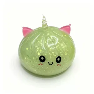 Λεπτομέρεια πράσινου dumpling squishy με κέρας μονόκερου και χρυσόσκονη.