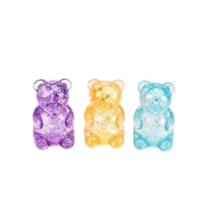 Colorful aurora glitter gummy bear squishy stress relief toys set on white background.