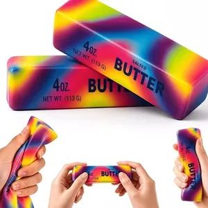 Close-up detail showing hands squeezing rainbow butter slow rebound stress toy