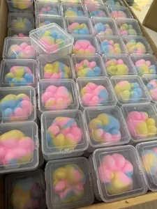 Bulk display of colorful macaron cat paw squishy toys in clear square plastic boxes