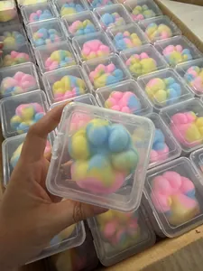 Close-up detail of a colorful cat paw squishy toy packaged in a clear plastic box