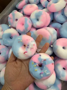 Colorful marble squishy donut toy for stress relief with sprinkles decoration.