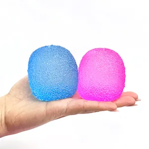 Hand holding two colorful maltose squishy stress toys with textured surface.