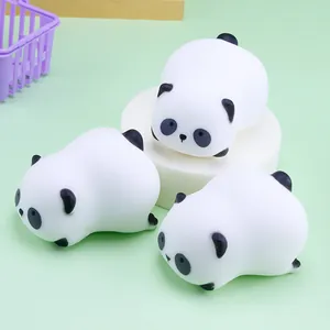 Detailed view of three soft panda squishy toys for stress relief on a green background