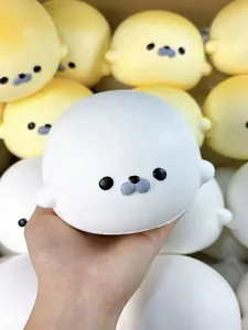 Close-up view showing the soft texture of a white seal squishy slow rising stress relief toy.