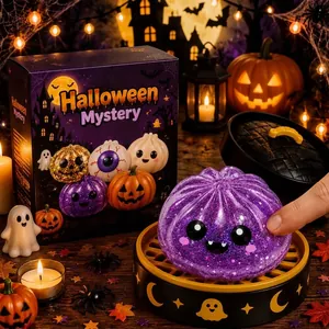 Detail view of purple glitter pumpkin squeeze toy from a Halloween mystery box set