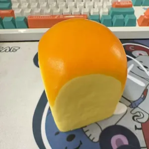 Macro detail view of realistic yellow bread loaf squishy toy with slow rising PU texture